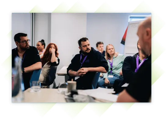 A team member listening in a conference room at the Customer Summit.