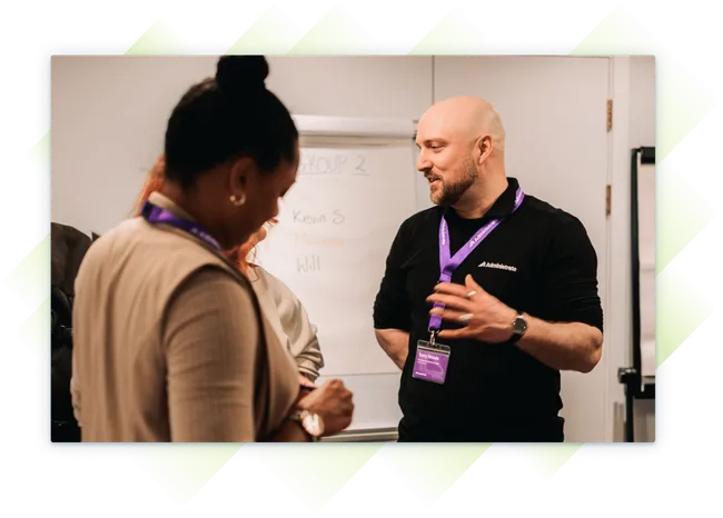 Administrate employee having a discussion with customers at our Customer Summit.