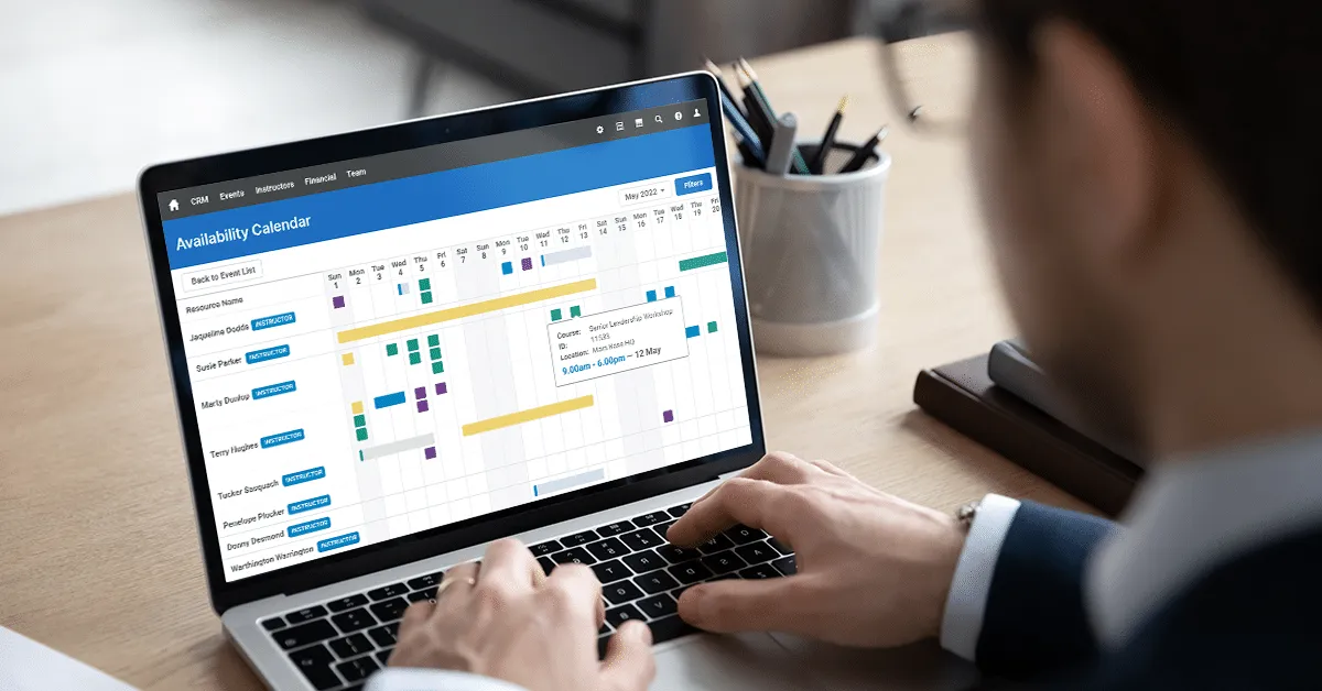 Training professional looking at the Availability Calendar feature of Administrate on their laptop.