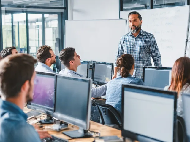 Instructor leads a group of corporate learners in an ILT session