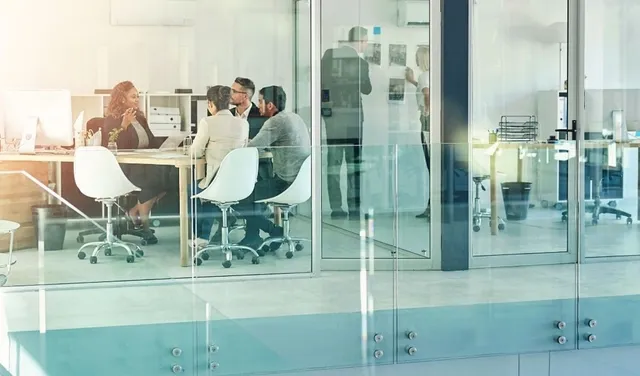 Group of training professionals in an office setting at a table.
