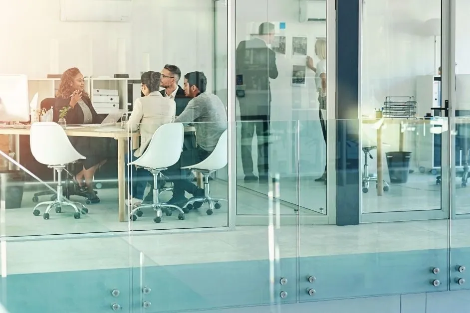 Group of training professionals in an office setting at a table.
