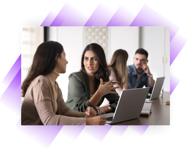 Woman accountant explaining something to an apprentice in an office setting.