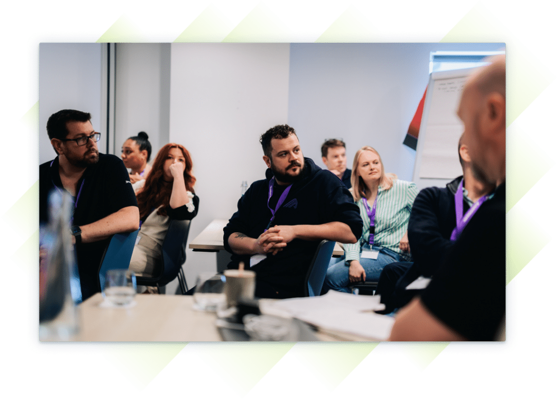 A team member listening in a conference room at the Customer Summit.